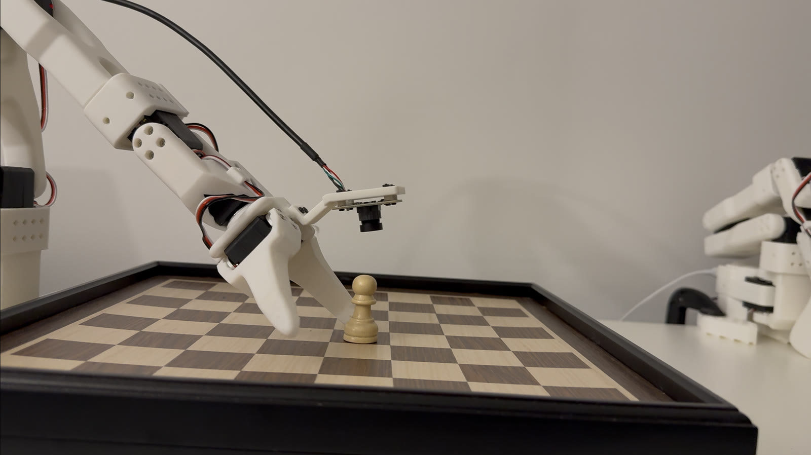 SO-101 robot arm reaching toward a chess pawn on a chessboard.